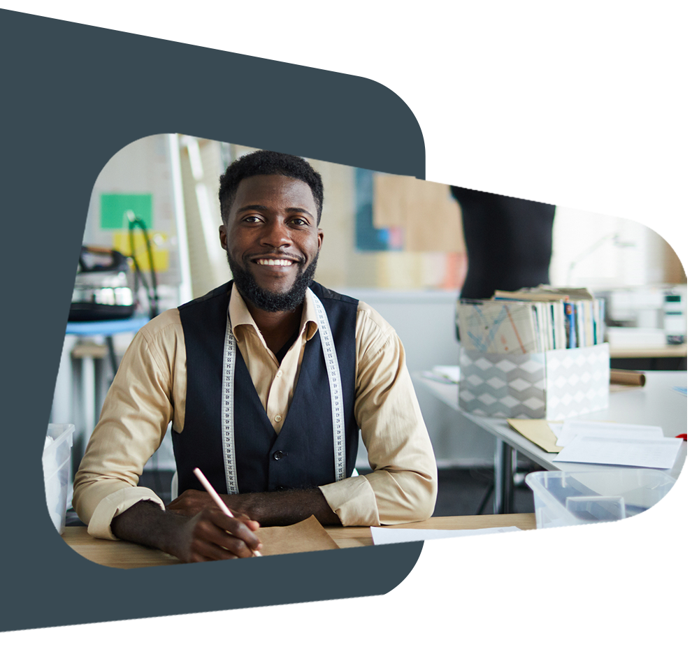 Black entrepreneur smiling with measuring tape.